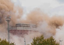Dust rises over the demolition site.